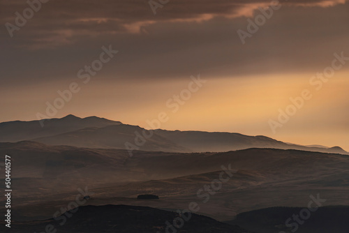 Snowdonia Wales morning landscape view with mist and orange sky