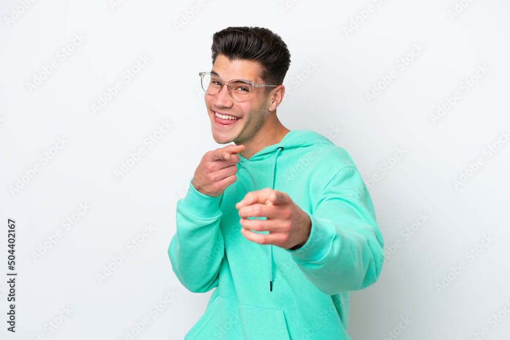Young handsome caucasian man isolated on white bakcground pointing to the front and smiling Young handsome caucasian man isolated on white bakcground pointing to the front and smiling