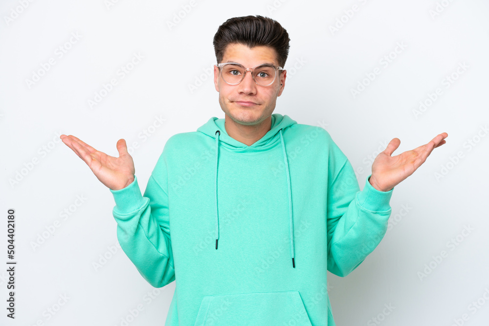 Young handsome caucasian man isolated on white bakcground making doubts gesture