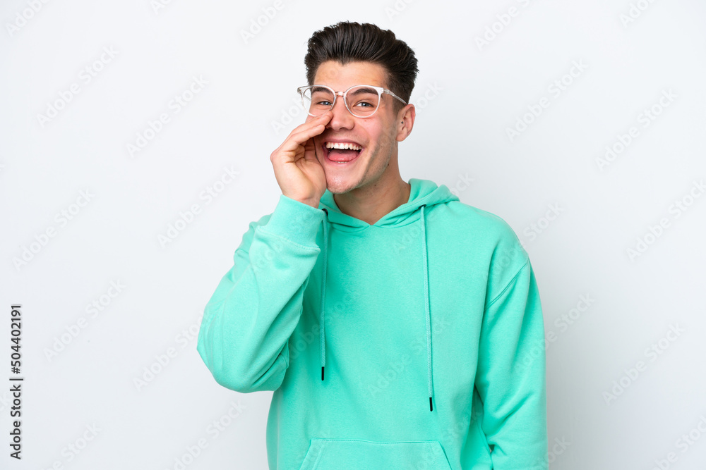 Young handsome caucasian man isolated on white bakcground shouting with mouth wide open Young handsome caucasian man isolated on white bakcground shouting with mouth wide open
