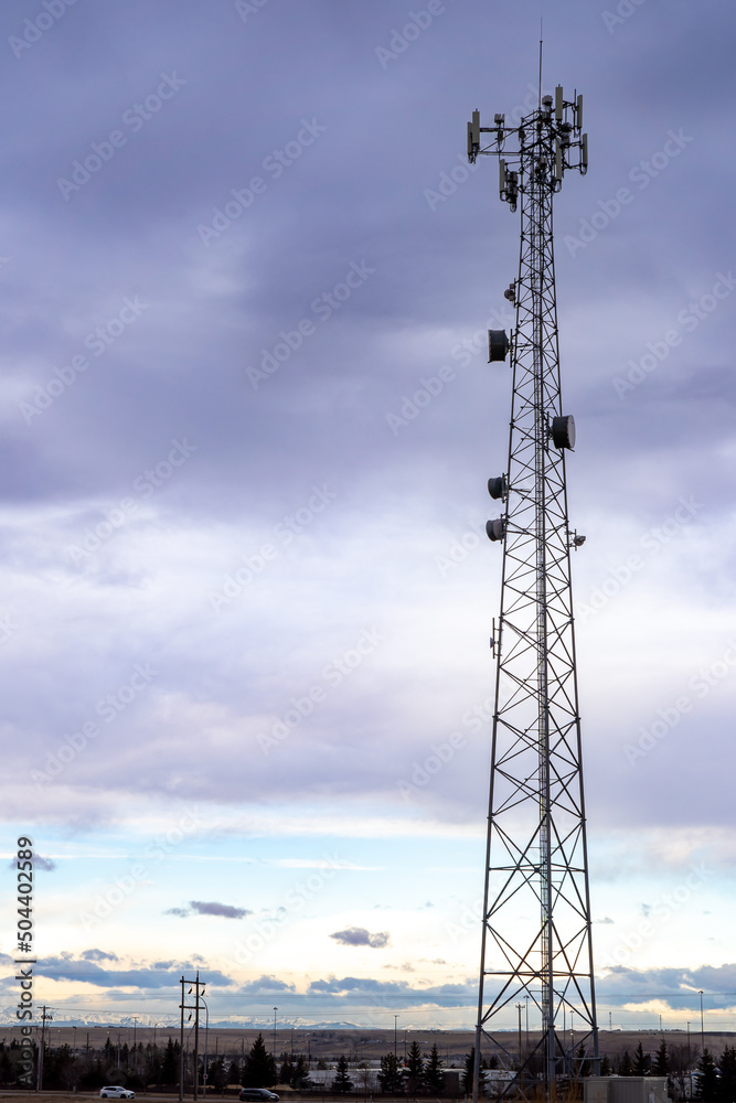 A cell phone tower and communications antenna at a natural park in Airdrie Alberta Canada. A cell phone tower and communications antenna at a natural park in Airdrie Alberta Canada.