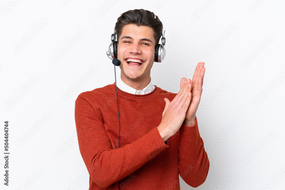 Fototapeta premium Telemarketer caucasian man working with a headset isolated on white background applauding after presentation in a conference