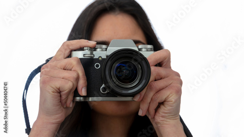 Young woman photographer hold photo camera is shoot your picture isolated on white, close up