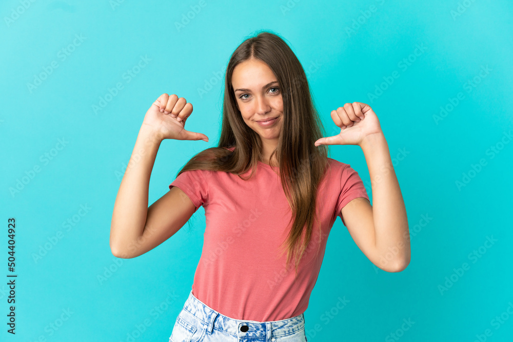 Young woman over isolated blue background proud and self-satisfied Young woman over isolated blue background proud and self-satisfied
