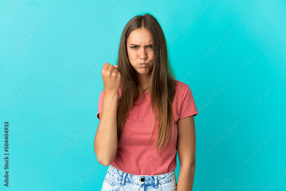 Fototapeta premium Young woman over isolated blue background with unhappy expression