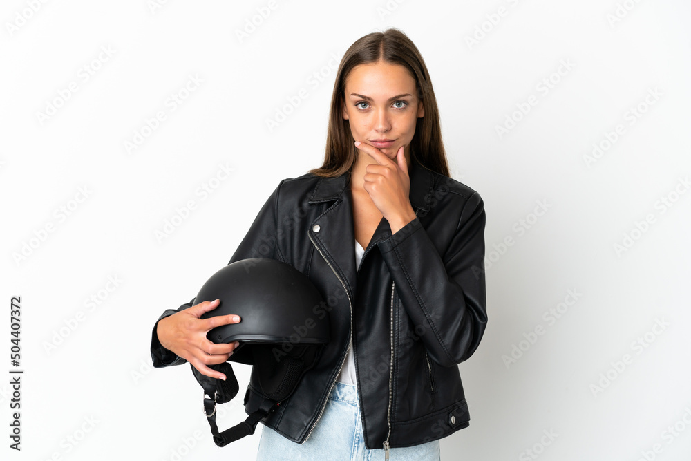 Woman with a motorcycle helmet over isolated white background thinking Woman with a motorcycle helmet over isolated white background thinking