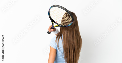 Young woman over isolated white background playing tennis © luismolinero
