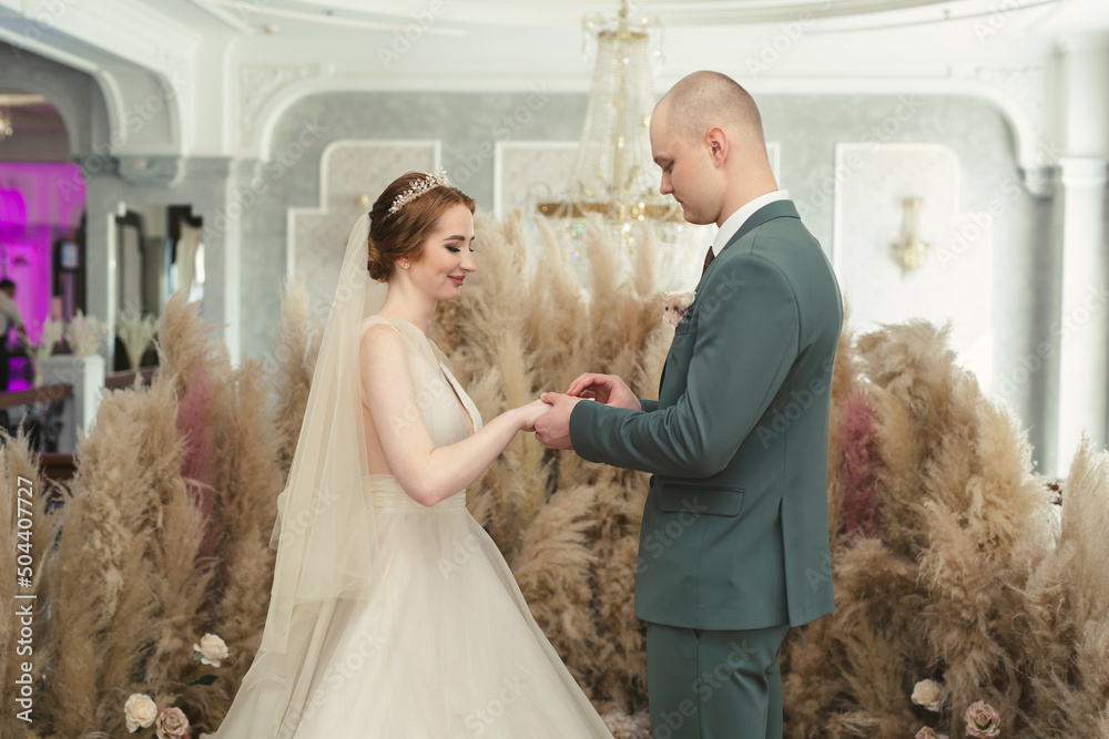Newlyweds exchange rings during their beautiful wedding ceremony Newlyweds exchange rings during their beautiful wedding ceremony