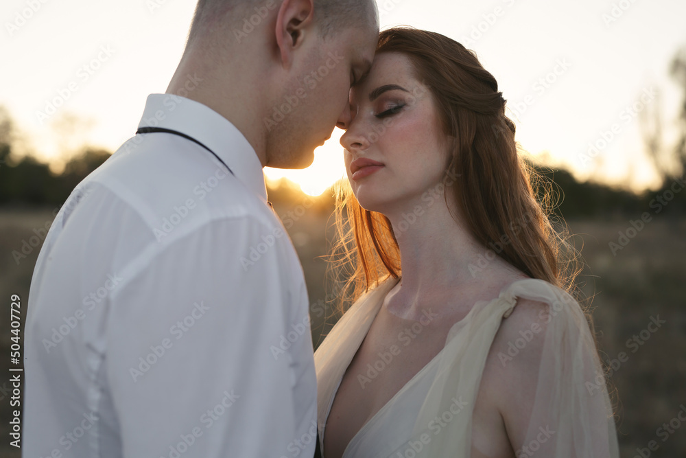 A beautiful couple of newlyweds at sunset A beautiful couple of newlyweds at sunset