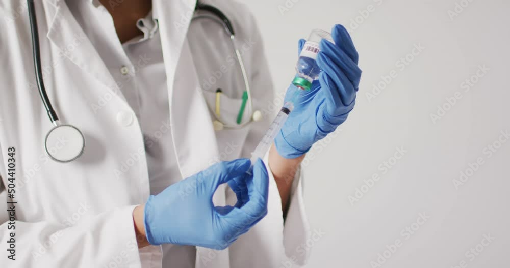 Video of biracial female doctor holding vaccine vial on white background Video of biracial female doctor holding vaccine vial on white background