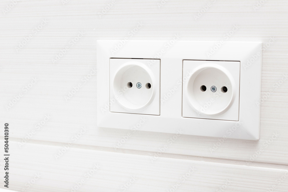 socket on light tiles in the bathroom. close-up socket on light tiles in the bathroom. close-up