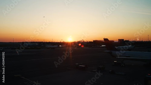 Sunset over JFK International Airport with the Manhattan skyline in the distance photo