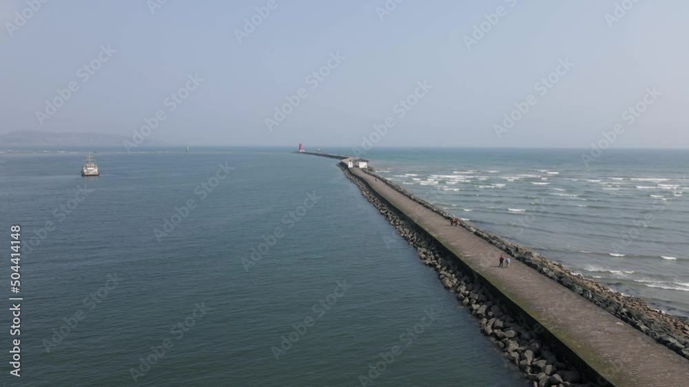 Drone shot of a long pier in Dublin, Ireland on a sunny day. Drone shot of a long pier in Dublin, Ireland on a sunny day.