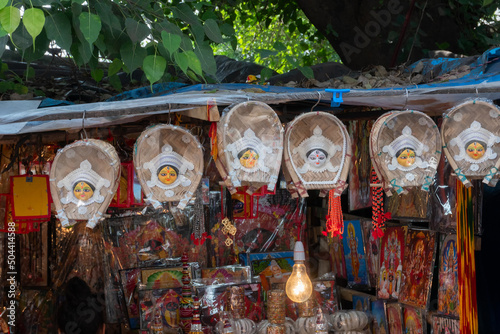 Indian Hindu Goddess Durga showpices for sale , made of Shola or Sola pith - or the Indian cork. It is a milky-white sponge-wood which is carved into objects of art. Kolkata street, West Bengal, India photo