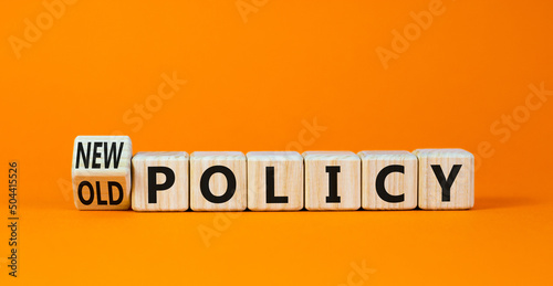 New or old policy symbol. Turned wooden cubes changed concept words Old policy to New policy. Beautiful orange table orange background. Business old or new policy concept. Copy space. photo