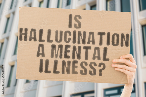 The question " Is hallucination a mental illness? " is on a banner in men's hands with blurred background. Emotional. Ill. Medicine. Mind. Panic. Stressed. Sick. Lonely. Medical. Social. Victim