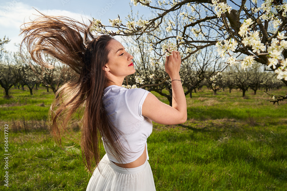 Beautiful woman in a plum orchard in bloom Beautiful woman in a plum orchard in bloom