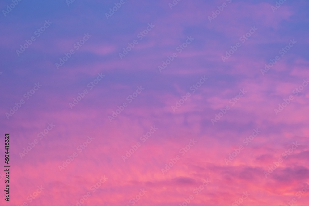 Bright colored clouds on dramatic sunset sky horizontal background.