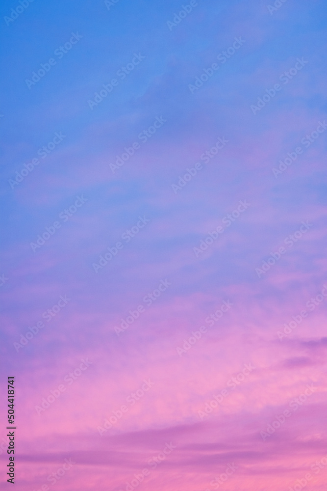 Bright colored clouds on dramatic sunset sky vertical background.