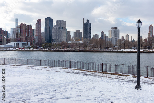 Roosevelt Island and Manhattan Skyline along the East River seen from Rainey Park covered in Snow in Astoria Queens New York during the Winter