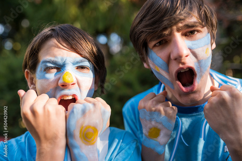 Friends cheering and shouting the goals of the Argentine soccer team. photo