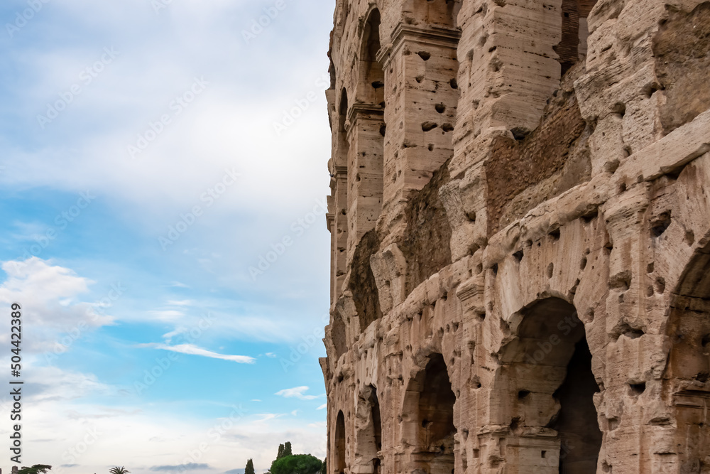 Exterior view of facade of famous Colosseum of city of Rome, Lazio, Italy, Europe. UNESCO World Heritage Site. Coloseo, Flavian Amphitheater the symbol of ancient Roma city in Roman Empire