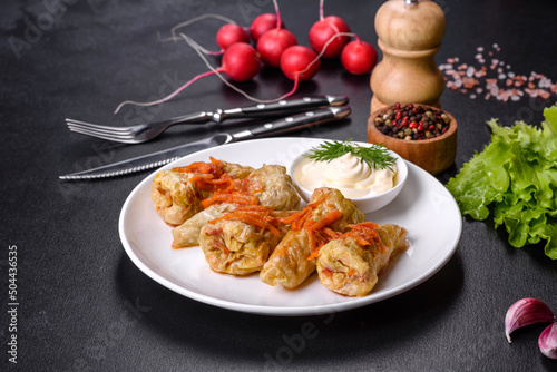 Cabbage rolls stuffed with ground beef and rice served on a white plate photo
