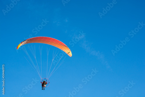 paraglider on the blue sky background 