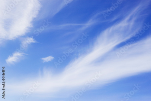blue sky with diagonal wavy clouds