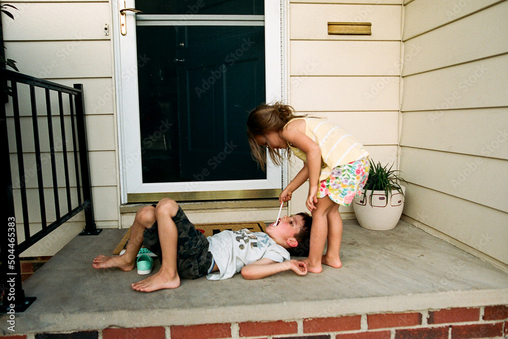 little sister plays dentist with brother Stock Photo Adobe Stock