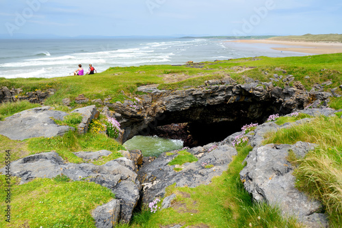 Fairy bridges, impressive stone arches near Tullan Strand, one of Donegals surf beaches, framed by a scenic back drop provided by the Sligo-Leitrim Mountains, Ireland © MNStudio