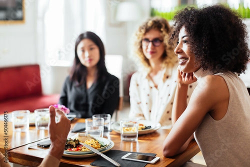 Black woman listening to friend in cafe