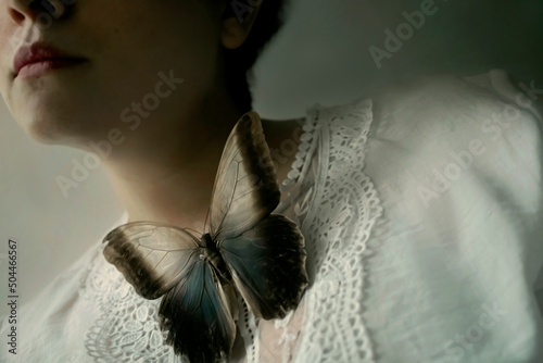 Women with a butterfly in her neck photo