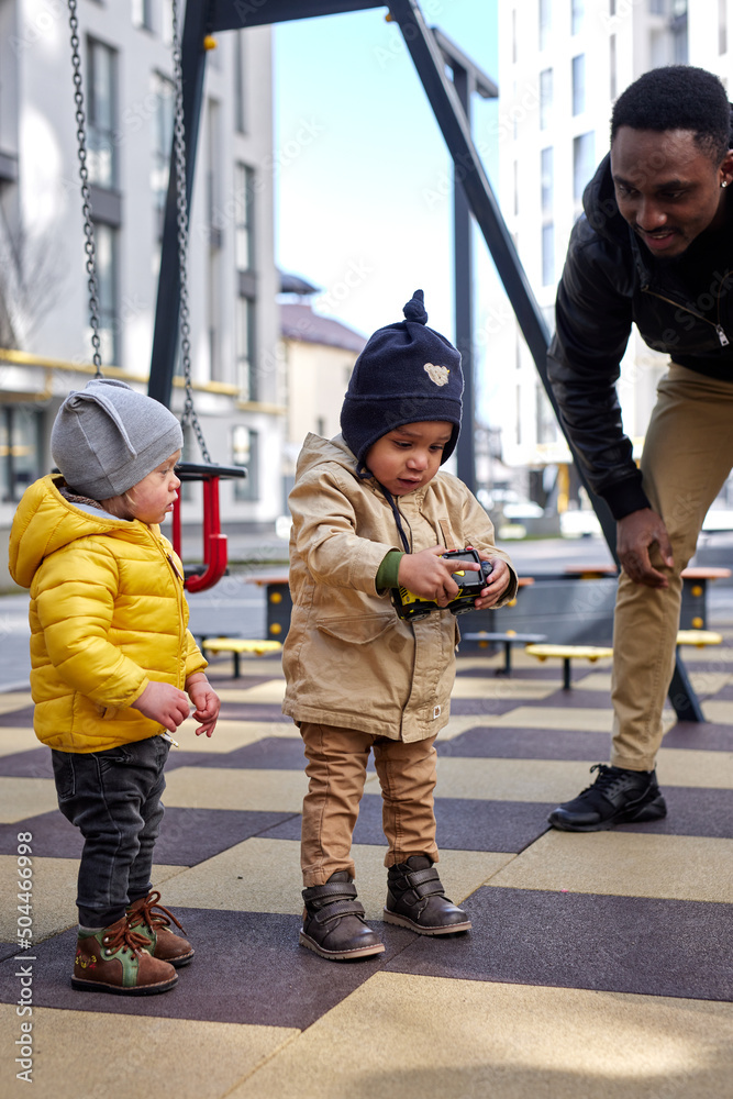 Father spendind time woth kids on playground Father spendind time woth kids on playground