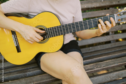 Female hands with guitar 