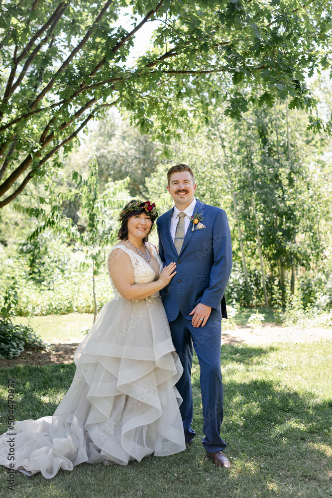 Portrait of Smiling Bride and Groom in Sunny Garden Portrait of Smiling Bride and Groom in Sunny Garden