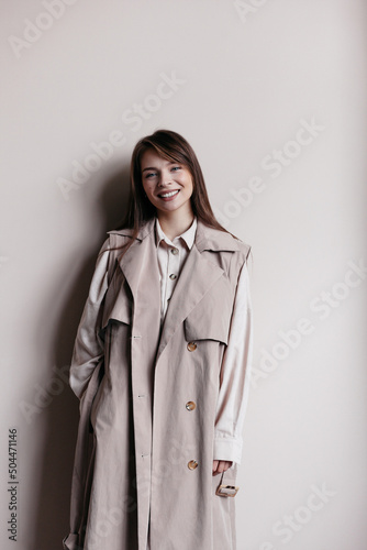 Smiling woman in stylish beige trench photo