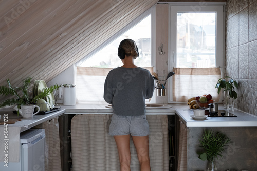 Unrecognizable woman washing dishes in morning