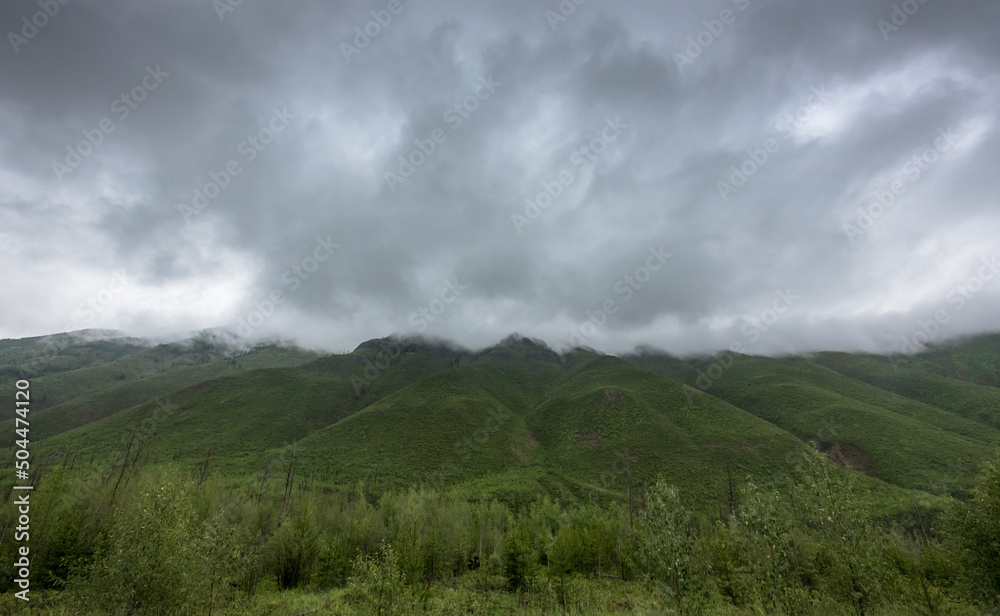 Thick Rain Clouds Over Green Mountains