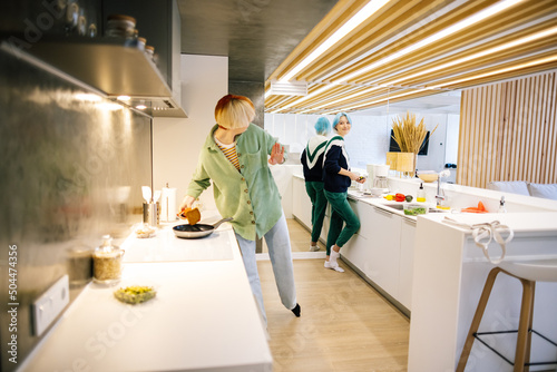 Lesbian couple making dish in kitchen together 