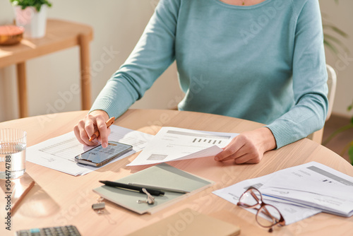 Woman managing personal budget at home