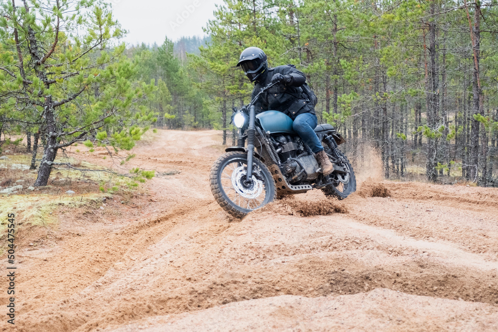 Rider rides on the scrambler on the deep sand Rider rides on the scrambler on the deep sand