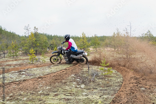 Rider aggressively turns with a skid on a motorcycle photo