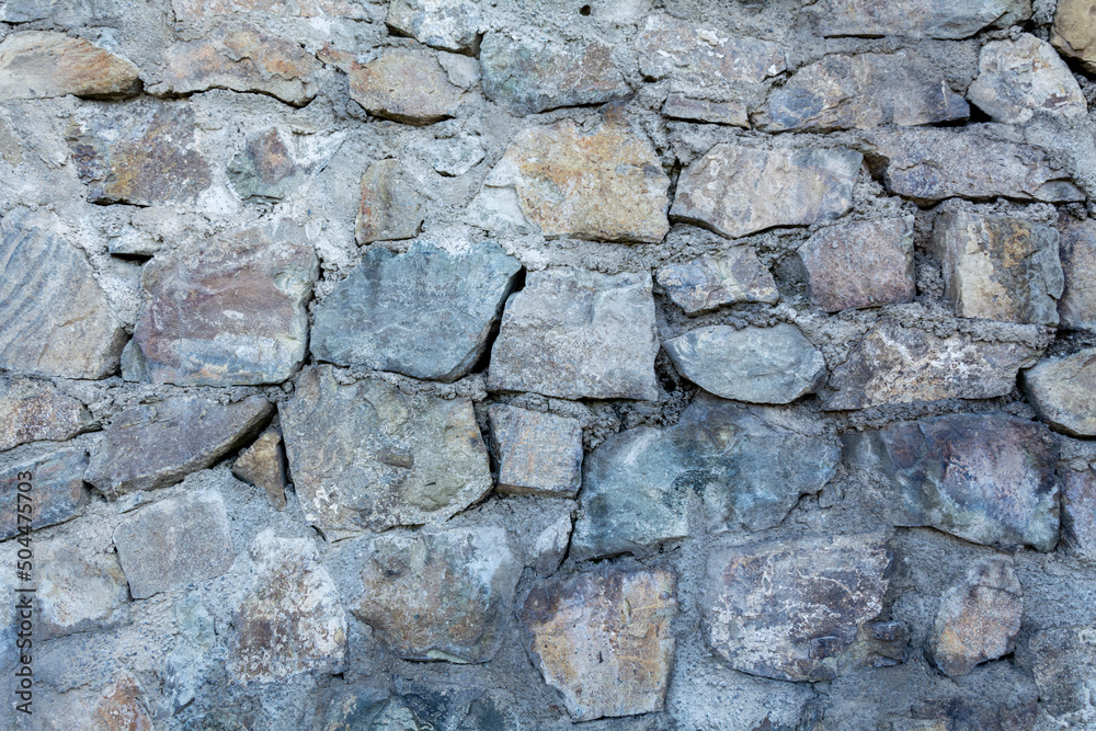 Background wall of stone. Wallpaper large cobblestones.