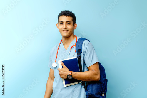 Obraz na plátne medical student with backpack holding books looking at camera.