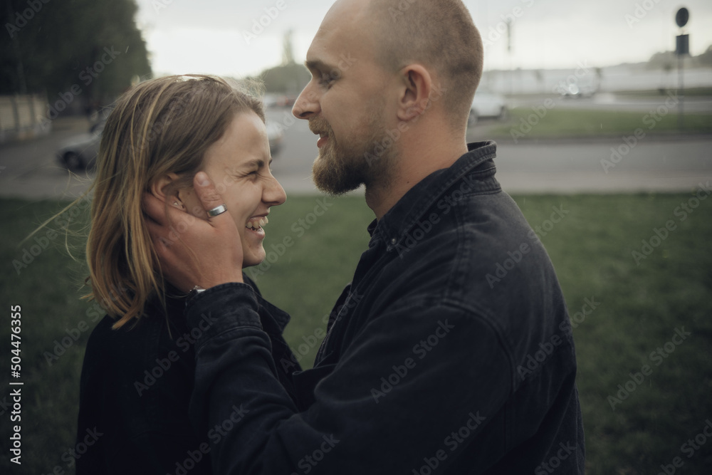 guy gently kisses his beloved holding hands on her face guy gently kisses his beloved holding hands on her face