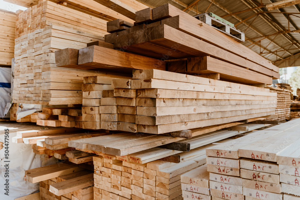 Pile of Wooden boards at lumber mill in a barn Pile of Wooden boards at lumber mill in a barn