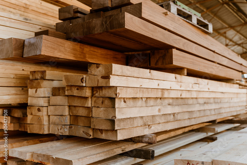 Detail image Pile of Wooden boards at lumber mill in a barn photo