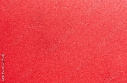 abstract red background or christmas paper with fine glitter