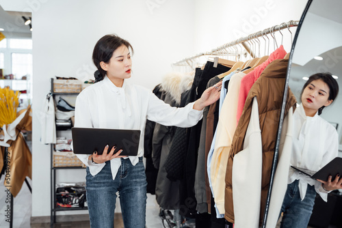 Young woman working in her clothing store photo